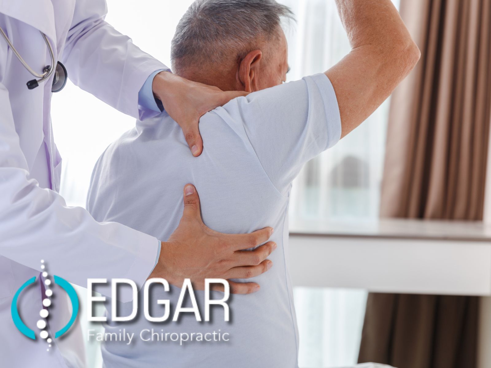 A client lifting his right arm in the air, while a doctor is grasping his right shoulder and right lower back to feel for any discomfort.