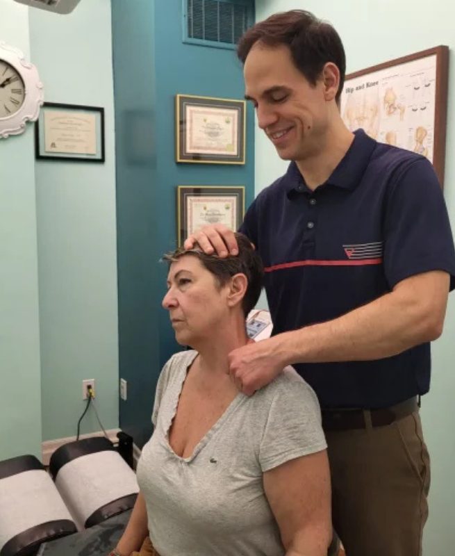 dr edgar performing an analysis on back and neck pain